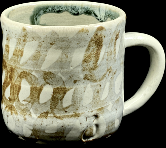 a mug with white glaze and brown circles.