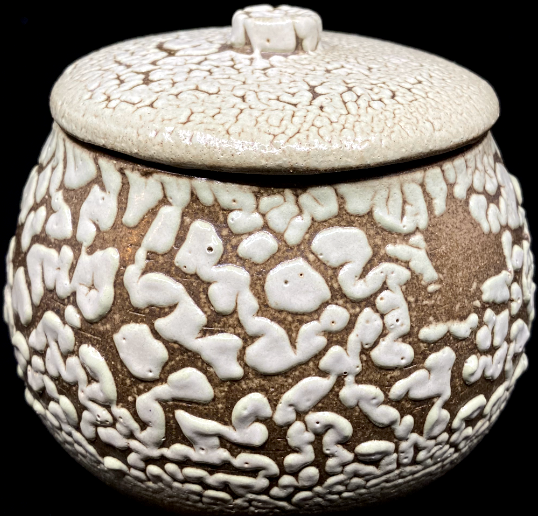 a stoneware jar with a white crawl glaze