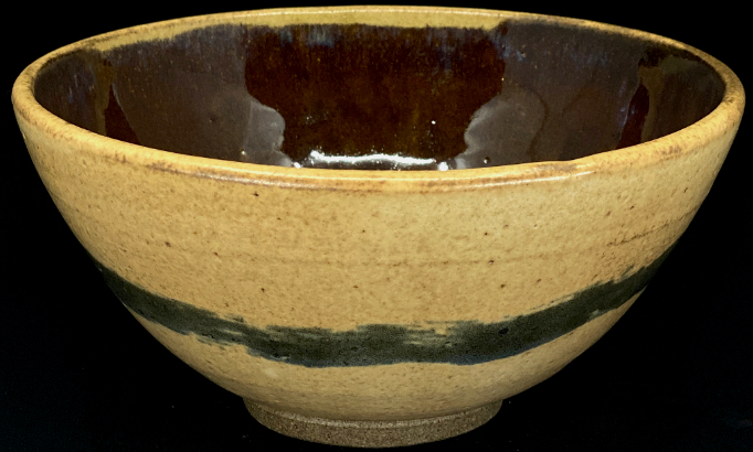 a matte stoneware bowl with a single cobalt stripe