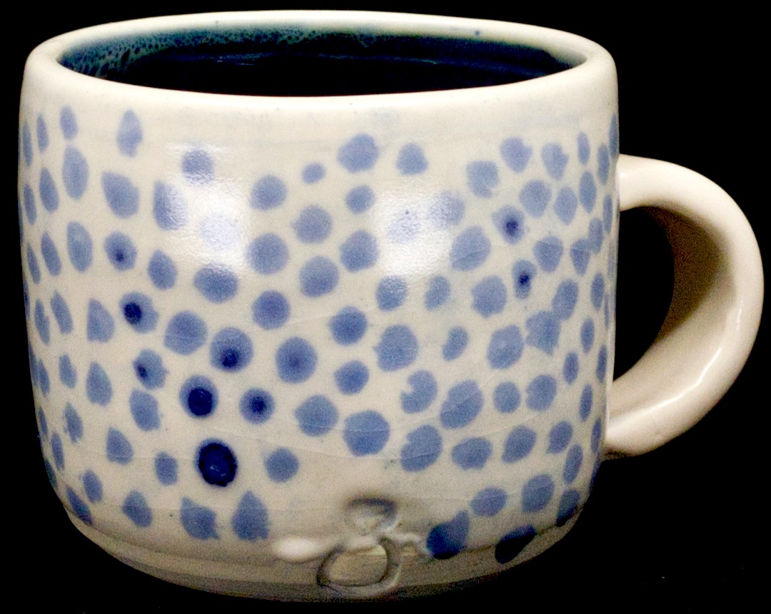 a white mug with blue cobalt spots
