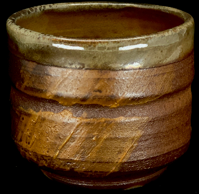 a woodfired cup with a simple slip application
